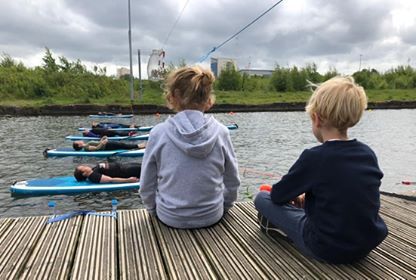 a young boy sitting at a dock