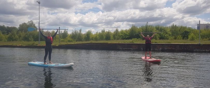 a person riding on the back of a boat in a body of water