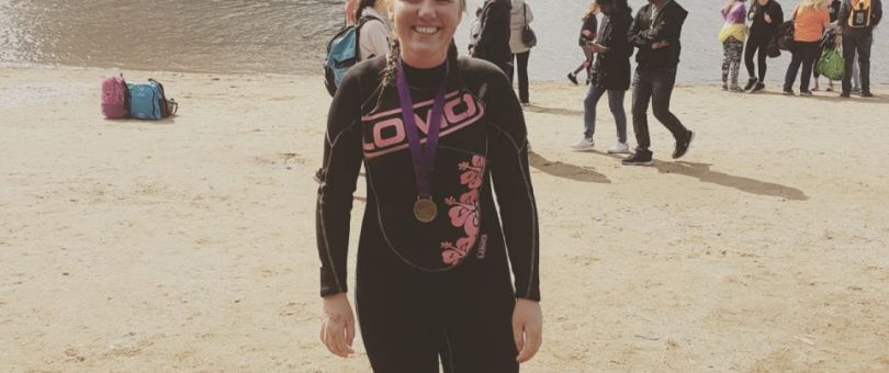 a group of people standing on top of a sandy beach