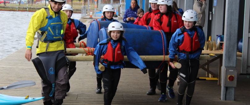 a group of people standing next to a little boy wearing a hat