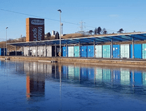 a train traveling down train tracks next to a body of water