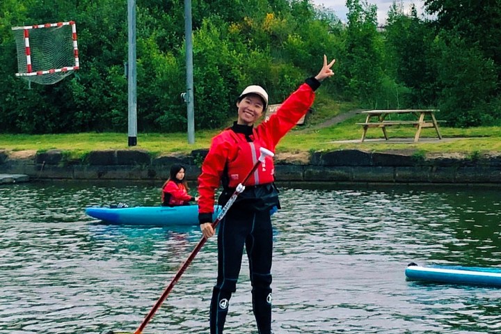 a person riding on the back of a boat in the water
