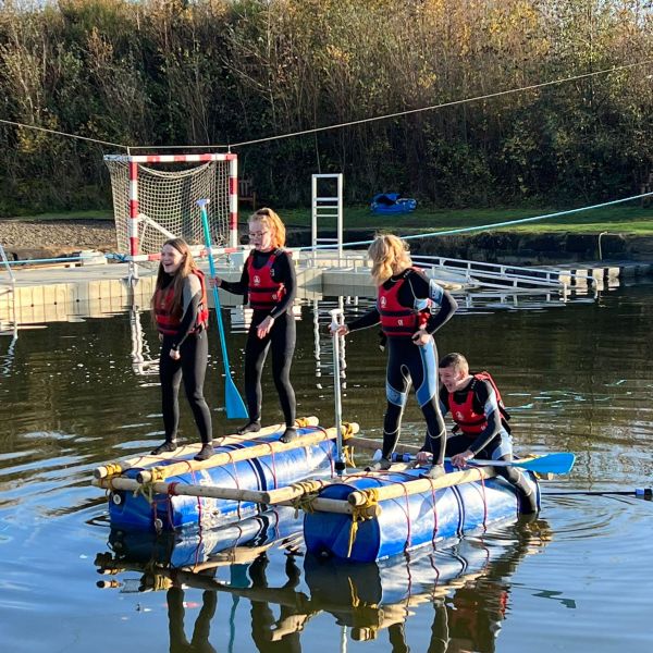a group of people on a boat in the water