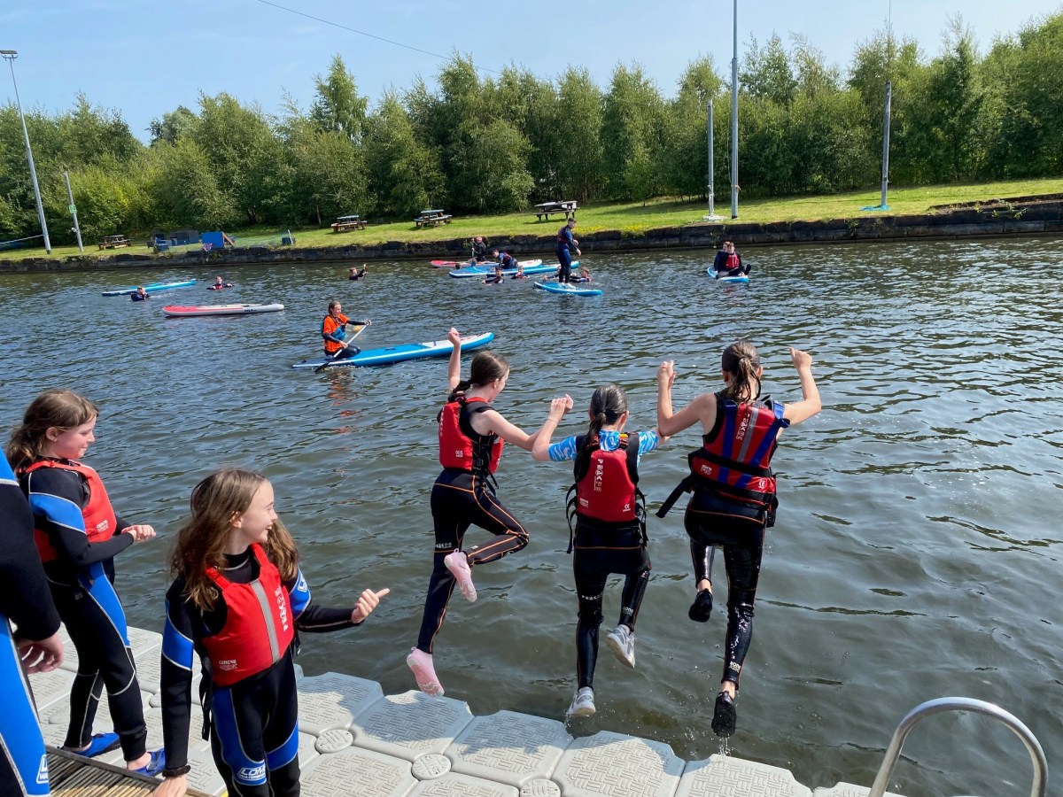 a group of people riding skis on a lake