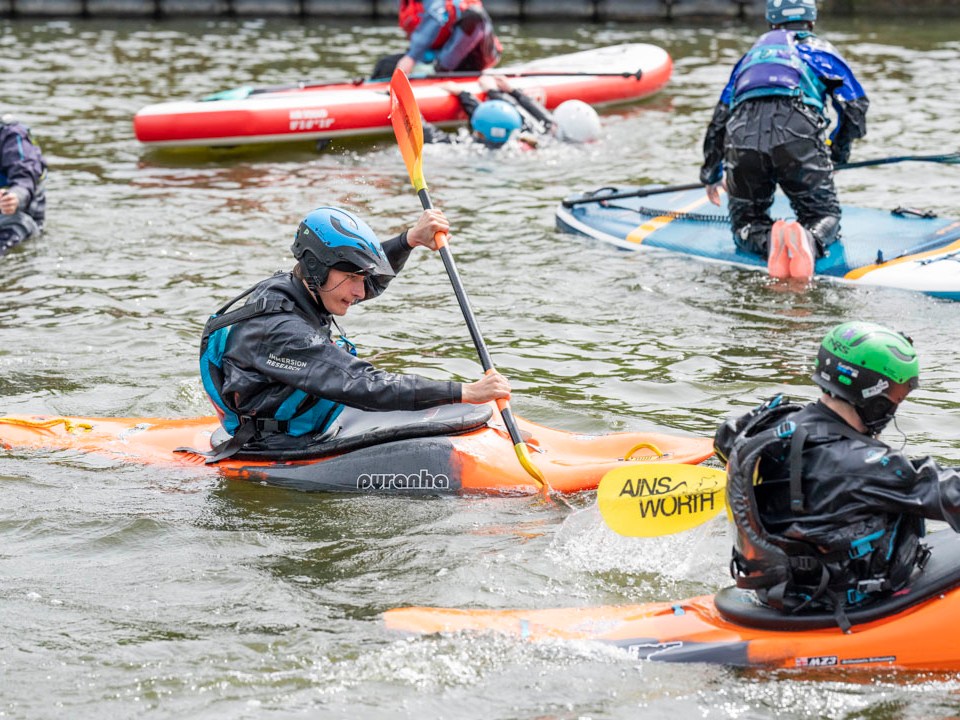 a group of people rowing a boat in the water