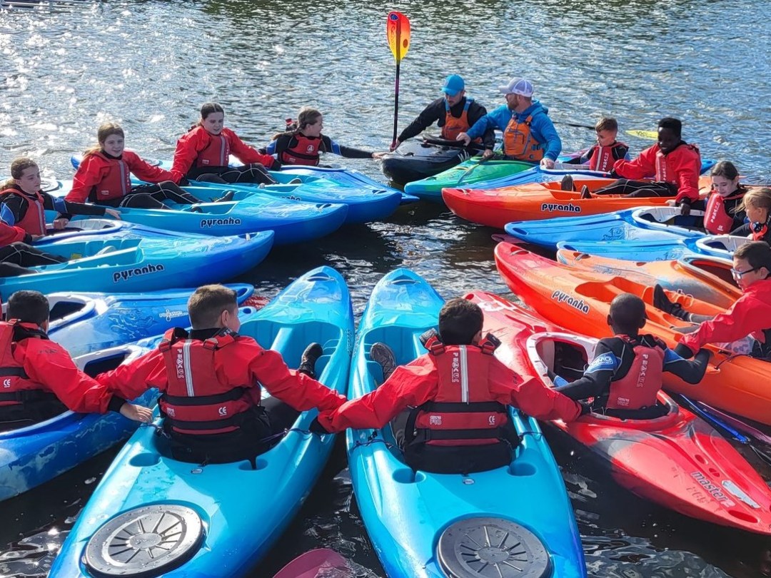 a group of people on a raft in a body of water