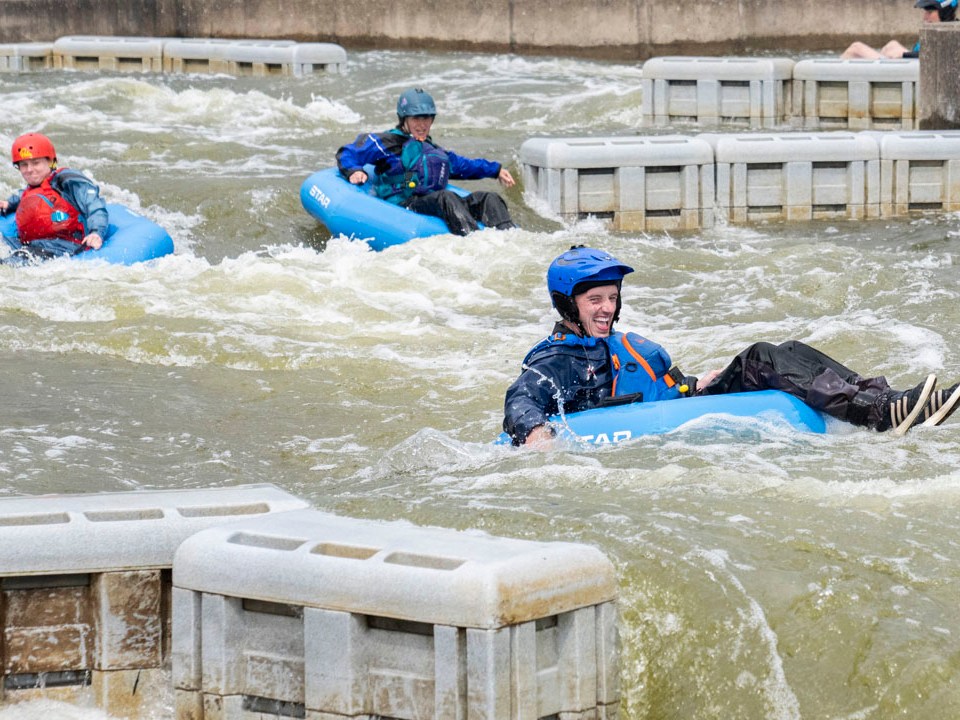 a group of people on a raft in a body of water