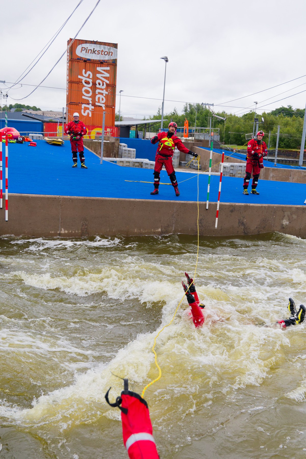 1138 a group of people throwing a line to a person in the water