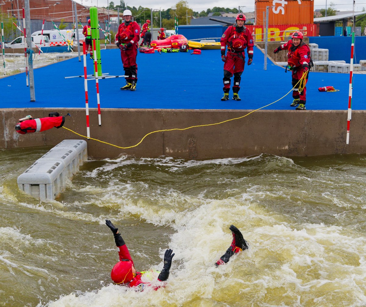 1192 a group of people throwing a line to a person in the water