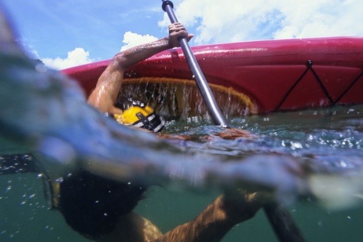 Person kayaking underwater view, paddling with visible kayak and waterline.